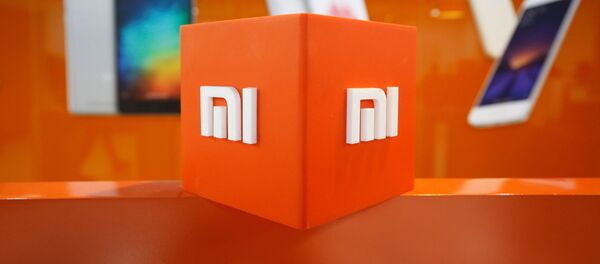 El logo de Xiaomi - Sputnik Mundo
