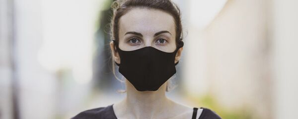 Una mujer con mascarilla (imagen referencial) - Sputnik Mundo