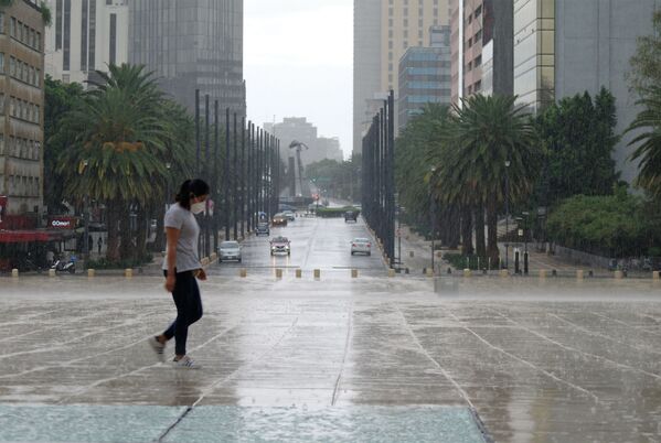 Una muchacha atraviesa justo frente al Monumento a la Revolución - Sputnik Mundo
