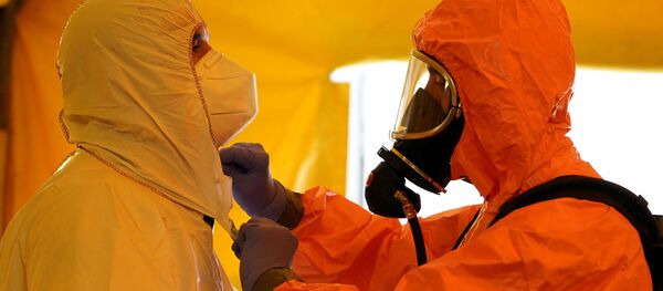 Un miembro del Servicio de Ambulancias de Madrid ajusta el equipo de protección de su colega. Madrid, 26 de agosto de 2020 - Sputnik Mundo