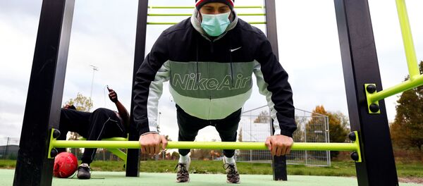 Un persona con mascarilla practica actividades físicas en Bruselas (archivo) - Sputnik Mundo