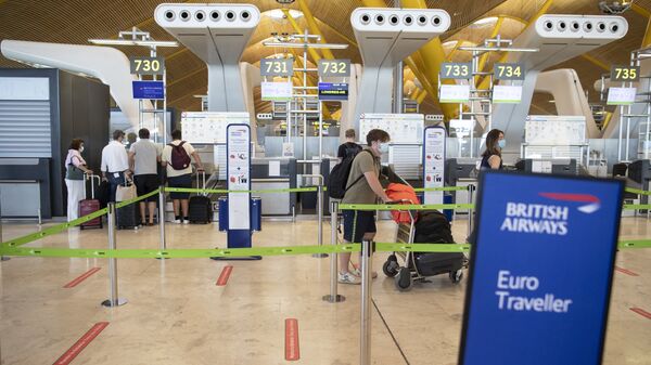 Pasajeros hacen cola en un mostrador de facturación de British Airways en el aeropuerto internacional Adolfo Suárez-Barajas. - Sputnik Mundo