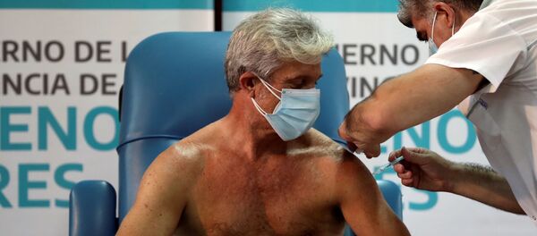 El doctor Emilio Macia, de 52 años, recibe la vacuna contra el coronavirus Sputnik V en el hospital de Avellaneda de Buenos Aires (Argentina), el 29 de diciembre del 2020 - Sputnik Mundo