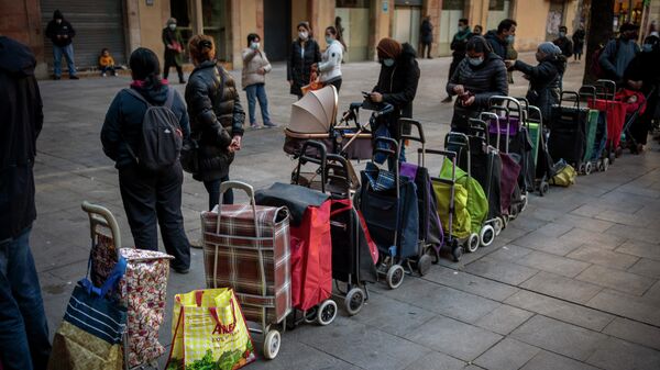 Carritos de compras alineados junto a sus dueños en una cola del hambre.  - Sputnik Mundo