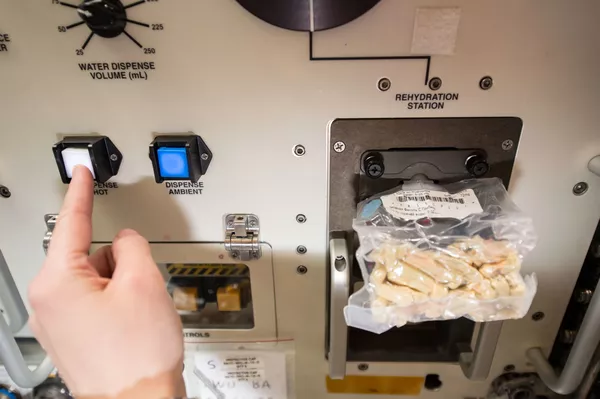 La astronauta de la Agencia Espacial Europea Samantha Cristoforetti prepara su almuerzo con un rehidratador de alimentos espaciales a bordo de la EEI. La astronauta de la Agencia Espacial Europea Samantha Cristoforetti prepara su almuerzo con un rehidratador de alimentos espaciales a bordo de la EEI. - Sputnik Mundo