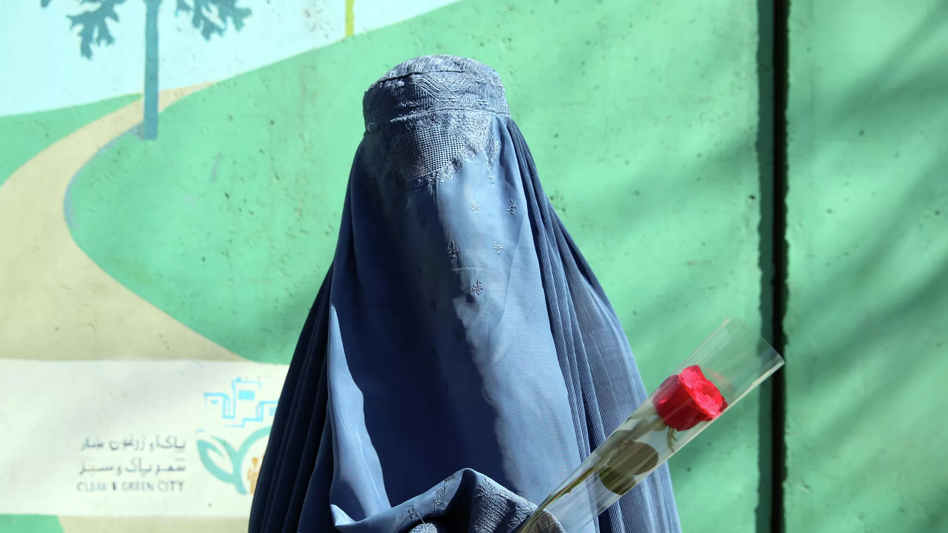 Una mujer sostiene una rosa en Kabul, Afganistán Una mujer sostiene una rosa en Kabul, Afganistán - Sputnik Mundo, 1920, 19.08.2021