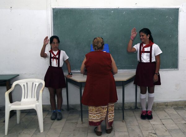 En Cuba, los uniformes son obligatorios no sólo para los escolares sino también para los estudiantes. Se puede saber en qué grado está un niño por su color. - Sputnik Mundo