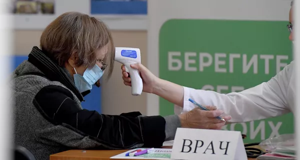 Medición de la temperatura de una ciudadana antes de entrar en el colegio electoral. Medición de la temperatura de una ciudadana antes de entrar en el colegio electoral. - Sputnik Mundo