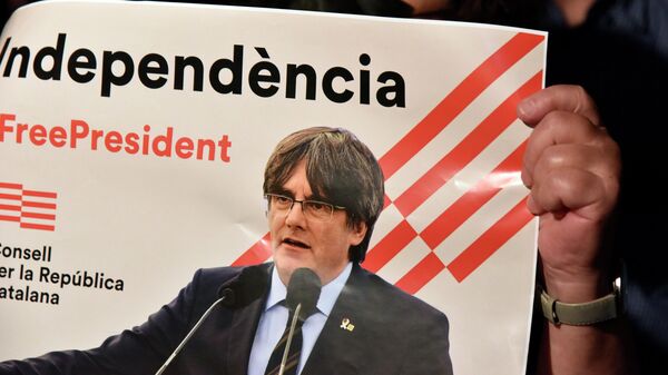 Una mujer sostiene una pancarta durante una concentración en apoyo al vicepresidente de la Generalitat, Carles Puigdemont, en la plaza de San Jaume de Barcelona - Sputnik Mundo