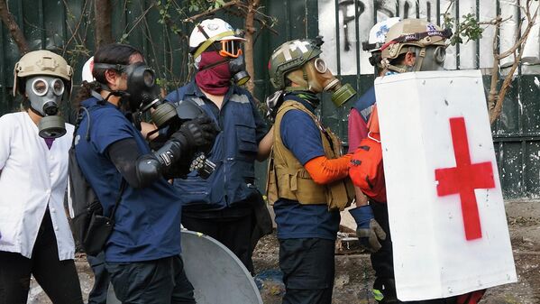 Brigadistas de primeros auxilios en las cercanías de la Plaza de la Dignidad. Brigadistas de primeros auxilios en las cercanías de la Plaza de la Dignidad. - Sputnik Mundo