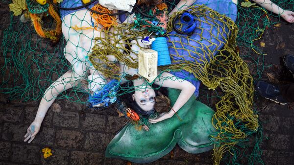 Activistas de Ocean Rebellion durante una actuación para protestar contra el uso de la pesca de arrastre de fondo en Glasgow (Escocia), antes de la inauguración de la 26ª conferencia de las Naciones Unidas sobre el cambio climático celebrada en esa ciudad el 30 de octubre de 2021. - Sputnik Mundo