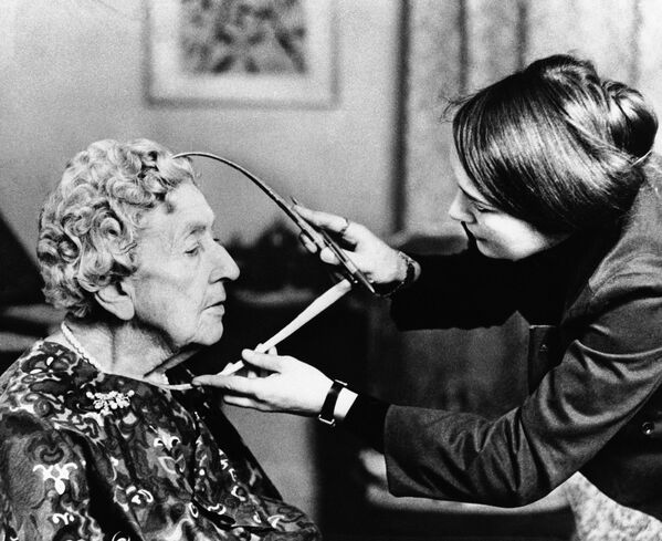 Tussaud creó máscaras mortuorias de la reina Maria Antonieta y los revolucionarios Maximiliano Robespierre y Jean-Paul Marat, entre otros.En la foto: una escultora toma medidas a la escritora Agatha Cristie, en 1972. - Sputnik Mundo