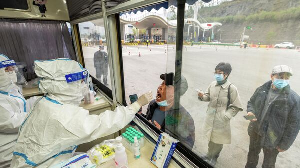 Un médico toma un hisopo de un hombre por el COVID-19 - Sputnik Mundo