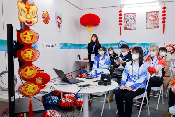 Los atletas también serán llevados a los lugares de entrenamiento y competencias en autobuses especiales con horarios predeterminados, excluyendo contactos innecesarios entre representantes de diferentes países.Foto: voluntarios durante una videoconferencia en el centro de prensa de los JJOO. - Sputnik Mundo