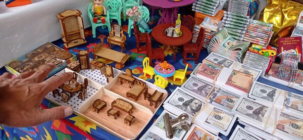 Una mano de tamaño promedio se ve gigante al lado de las delicadas artesanías elaboradas para esta festividad. - Sputnik Mundo