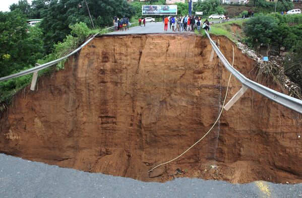 Varias personas quedaron varadas frente a un puente demolido en la ciudad de Ntuzuma, en Sudáfrica. Las prolongadas lluvias e inundaciones en la provincia sudafricana de KwaZulu-Natal se han cobrado decenas de vidas, según las autoridades locales. - Sputnik Mundo