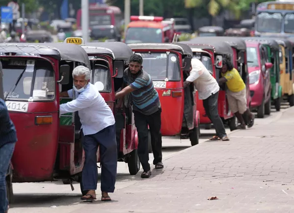Varios conductores de autos rickshaws (vehículos triciclos motorizados) en Sri Lanka hacen filas para comprar gasolina frente a una estación en la ciudad de Colombo. Varios conductores de autos rickshaws (vehículos triciclos motorizados) en Sri Lanka hacen filas para comprar gasolina frente a una estación en la ciudad de Colombo. - Sputnik Mundo