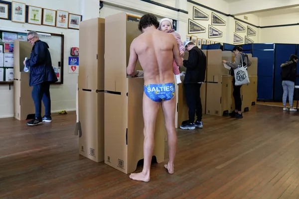 Un residente de Sídney y su hija pequeña, en uno de los colegios electorales de la ciudad durante las elecciones parlamentarias de Australia. Un residente de Sídney y su hija pequeña, en uno de los colegios electorales de la ciudad durante las elecciones parlamentarias de Australia. - Sputnik Mundo