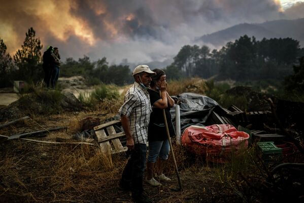 Los habitantes de la zona de Orjais, en el municipio de Covilha, en el centro de Portugal, contemplan el patrimonio mundial de la Unesco en la Sierra de la Estrella, el parque nacional envuelto en un incendio. - Sputnik Mundo
