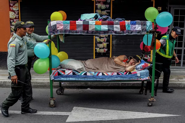 Policías empujan una cama mientras la gente celebra el Día Mundial de la Pereza en Itagüí, Colombia. Policías empujan una cama mientras la gente celebra el Día Mundial de la Pereza en Itagüí, Colombia. - Sputnik Mundo