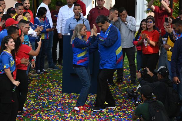 El presidente venezolano, Nicolás Maduro, y la primera dama, Cilia Flores, bailan frente al Palacio presidencial de Miraflores, en Caracas, durante una concentración por el Día de la Juventud. Este día festivo, que se celebra anualmente el 12 de febrero, se estableció para conmemorar a los adolescentes que murieron en la batalla por la independencia de Venezuela en La Victoria el 12 de febrero de 1814. - Sputnik Mundo