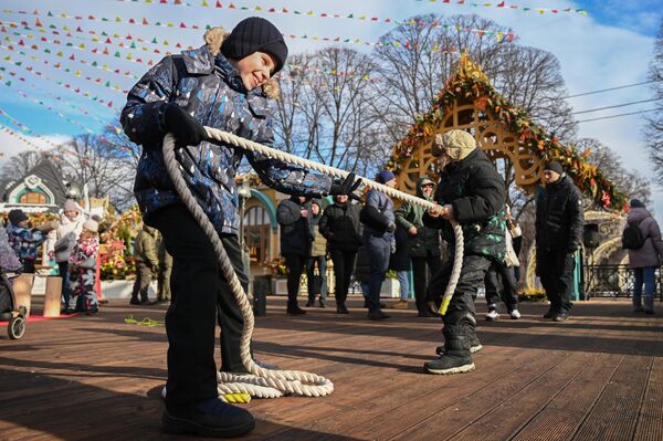 En esos días, los pueblos rusos celebraban tradicionalmente diversas competiciones como: saltos sobre hogueras, paseos a caballo y peleas a puñetazos que terminaban en ruidosas fiestas. El jueves se solía realizar una batalla por el castillo de nieve.En la foto: las personas visitan el festival de la Máslenitsa en el Parque Central de Cultura y Ocio de Moscú. - Sputnik Mundo