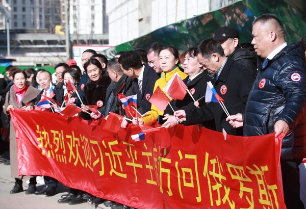 Xi Jinping se alojó en un hotel de cinco estrellas del norte de Moscú, junto a un parque paisajístico tradicional chino. Decenas de personas con banderas rusas y chinas lo recibieron a la entrada del hotel, así como una pancarta en la que se leía en chino "Cálida bienvenida a la visita del presidente Xi Jinping a Rusia". - Sputnik Mundo