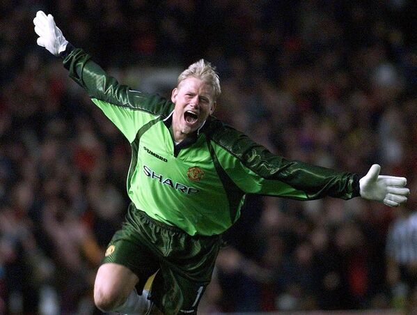 Peter Schmeichel se hizo conocido en la Eurocopa de 1992, asegurando la sorprendente victoria danesa con sus numerosas atajadas. Con 129 partidos internacionales, se convirtió en el jugador danés con más partidos de este nivel en la historia. Pasó ocho años en el Manchester United, ganando cinco títulos de la Premier League, tres FA Cups y un título de la Champions League  durante su último año en el club en 1999. - Sputnik Mundo