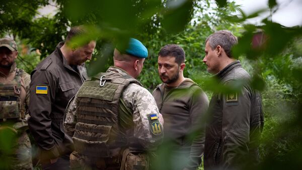 El presidente ucraniano, Volodímir Zelenski, habla con oficiales durante su visita a las posiciones avanzadas de las Fuerzas Armadas de Ucrania en la zona de defensa de Vugledar-Maryinka, región de Donetsk, el 23 de mayo de 2023 - Sputnik Mundo