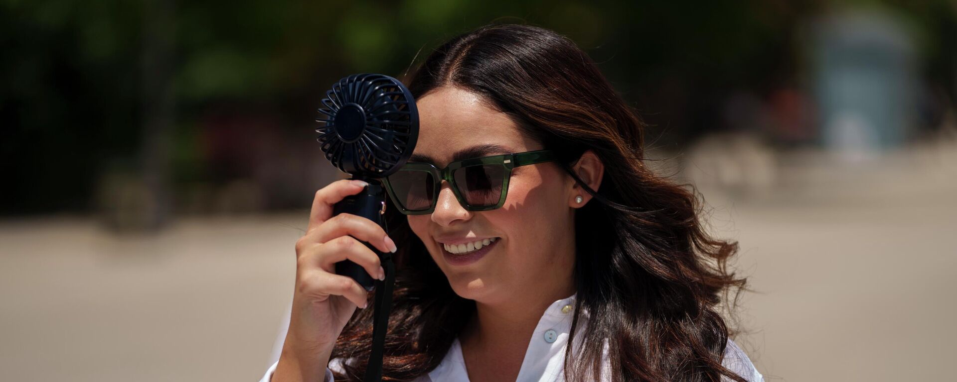 Una mujer usa un ventilador portátil en Madrid, España, el 17 de julio de 2023 - Sputnik Mundo, 1920, 11.08.2023