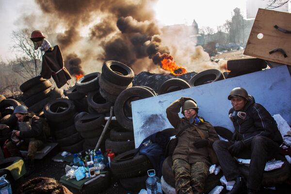 El 19 de enero, los radicales intentaron romper el cordón que rodeaba el barrio gubernamental, en el centro de Kiev, lanzando cócteles molotov contra las fuerzas especiales, a consecuencia de lo cual decenas de agentes del orden fueron hospitalizados. El 22 de enero se informó de la muerte de dos participantes en los enfrentamientos con la Policía. En la foto: participantes de la oposición radical en la barricada del centro de Kiev. - Sputnik Mundo