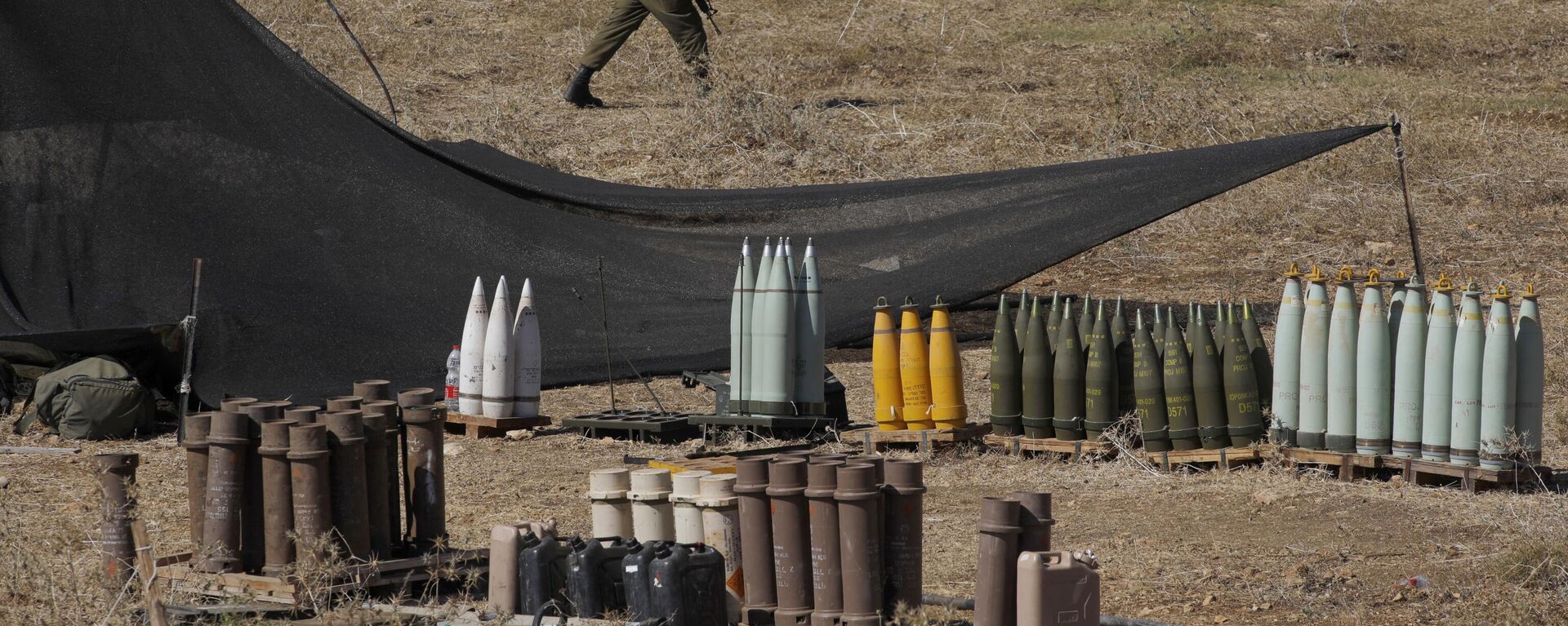 Un soldado israelí camina entre municiones 155 mm y otras más cerca de la frontera con el Líbano - Sputnik Mundo, 1920, 05.04.2024