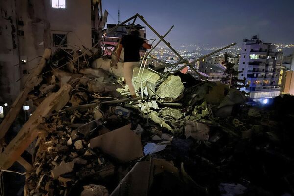 Un hombre inspecciona un edificio destruido por el ataque aéreo israelí en los suburbios del sur de Beirut, Líbano. - Sputnik Mundo