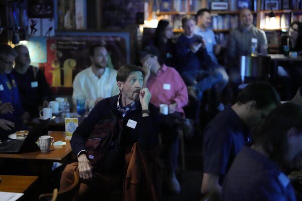 Unos clientes observan la pantalla que muestra una retransmisión en directo de los resultados de las elecciones en el bar Good Heavens, en Tokio. - Sputnik Mundo