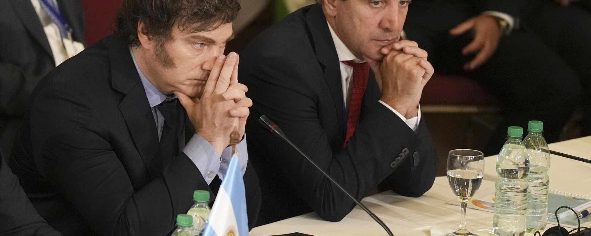 El presidente argentino, Javier Milei, y su ministro de Economía, Luis Caputo, asisten a la Cumbre del Mercosur en Montevideo, Uruguay, el 6 de diciembre de 2024 - Sputnik Mundo, 1920, 02.07.2025