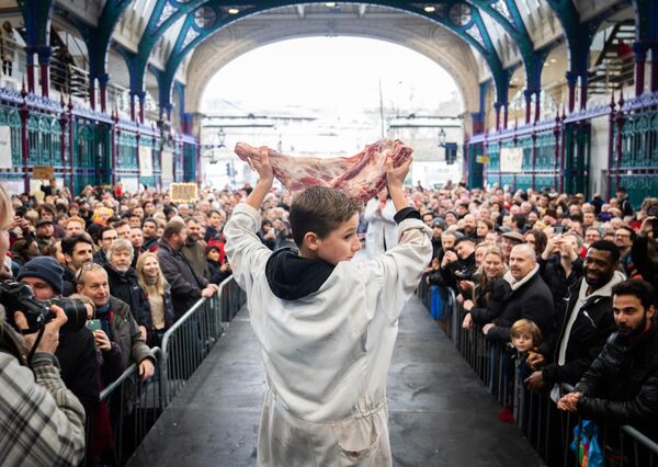 La subasta navideña de carne en el mercado de Smithfield, en Londres, es una tradición centenaria en la que los comerciantes ofrecen al público las sobras de carne a través de subastas. - Sputnik Mundo