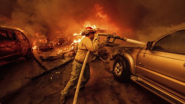 Un bombero combate los incendios en Altadena, California, este miércoles 8 de enero  - Sputnik Mundo