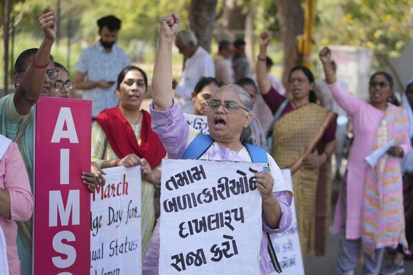 Varias mujeres gritan consignas durante una manifestación para conmemorar el Día Internacional de la Mujer en Ahmedabad, India.  - Sputnik Mundo