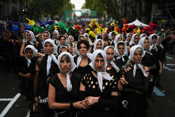 Mujeres vestidas como Madres de Plaza de Mayo marchan para conmemorar el aniversario del golpe de Estado de 1976 en Argentina, en la ciudad de Buenos Aires. Mujeres vestidas como Madres de Plaza de Mayo marchan para conmemorar el aniversario del golpe de Estado de 1976 en Argentina, en la ciudad de Buenos Aires. - Sputnik Mundo
