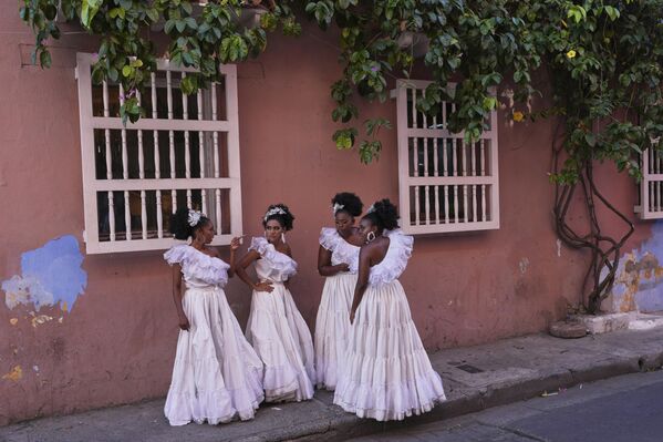 Bailarines se reúnen en las aceras después de actuar en una boda en Cartagena, Colombia. - Sputnik Mundo