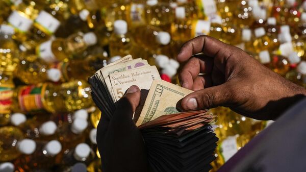 Dólares y bolívares - Sputnik Mundo