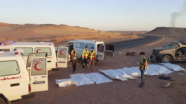 Rescatistas de los Servicios de Ambulancias y Emergencias de Kufra se preparan para trasladar los cuerpos de doce migrantes sudaneses que huían de la guerra civil en su país de origen y que murieron en un accidente automovilístico en el desierto, a 90 kilómetros al norte de la ciudad libia de Kufra, el viernes 30 de mayo de 2025.  - Sputnik Mundo