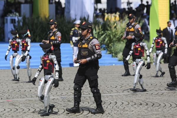 Robots controlados por oficiales de policía actúan durante la celebración del 79.º aniversario de la Policía Nacional de Indonesia, cerca del Monumento Nacional de Yakarta, Indonesia. Miles de policías participaron en el desfile, que incluyó una serie de demostraciones tácticas y unidades especializadas. Robots controlados por oficiales de policía actúan durante la celebración del 79.º aniversario de la Policía Nacional de Indonesia, cerca del Monumento Nacional de Yakarta, Indonesia. Miles de policías participaron en el desfile, que incluyó una serie de demostraciones tácticas y unidades especializadas. - Sputnik Mundo