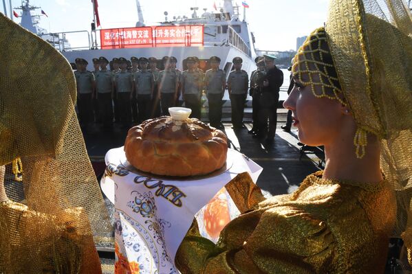 Jóvenes en la ceremonia de bienvenida a los barcos de la Guardia Costera de China en la ciudad rusa de Vladivostok.  - Sputnik Mundo