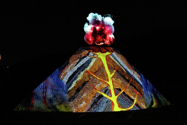 Instalaciones luminosas recrean el resplandor incandescente de las erupciones volcánicas y los fenómenos de luz geotérmica durante el festival En Camino hacia la Iluminación: Luces de la Naturaleza, celebrado en el Jardín de Plantas en París, Francia. - Sputnik Mundo