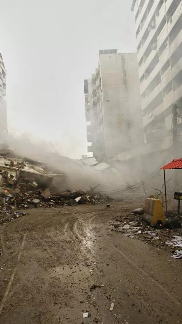 Un hombre toma fotografías de los escombros de los edificios destruidos en un ataque aéreo israelí en Dahié, en los suburbios del sur de Beirut, el Líbano, el 15 de marzo de 2026. Un hombre toma fotografías de los escombros de los edificios destruidos en un ataque aéreo israelí en Dahié, en los suburbios del sur de Beirut, el Líbano, el 15 de marzo de 2026. - Sputnik Mundo