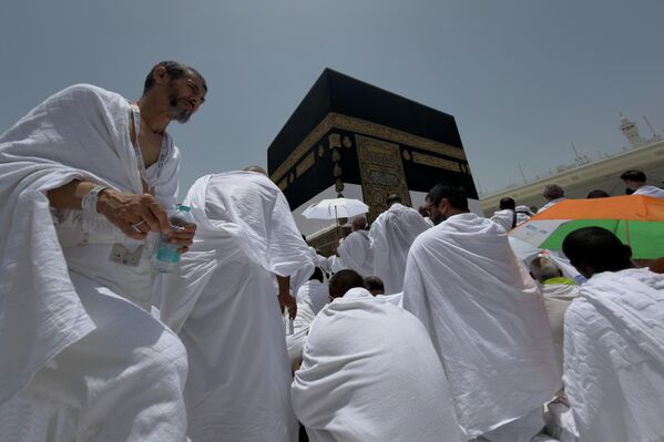 Peregrinos musulmanes rezan ante la Kaaba, el edificio cúbico de la Gran Mezquita, durante la peregrinación a La Meca, Arabia Saudita. - Sputnik Mundo