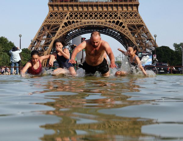 Personas buscan refrescarse cerca de la Torre Eiffel en París, en medio de una ola de calor sin precedentes. - Sputnik Mundo