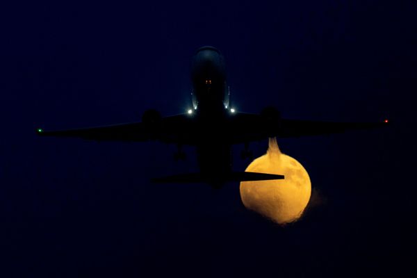 Un avión en pleno vuelo con el eclipse lunar de fondo, observado desde California, EEUU. - Sputnik Mundo