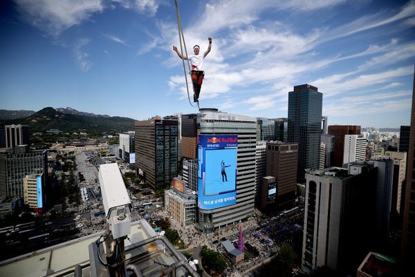 El slackliner estonio Jaan Roose realiza una exhibición sobre una cuerda floja durante el primer evento urbano de highline de Corea del Sur, sobre una línea de 160 metros de longitud suspendida a 120 metros del suelo, en el centro de Seúl, Corea del Sur. - Sputnik Mundo